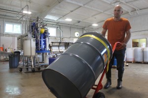 Full Sun Company employee, Zach Hartlyn, moves an off-spec oil barrel for biodiesel production Credit: Full Sun Company 
